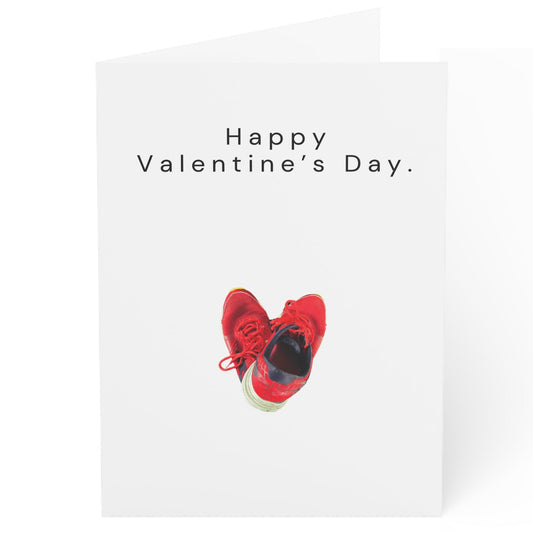 Valentine's Day card with red shoes and 'Happy Valentine's Day' text on a white background