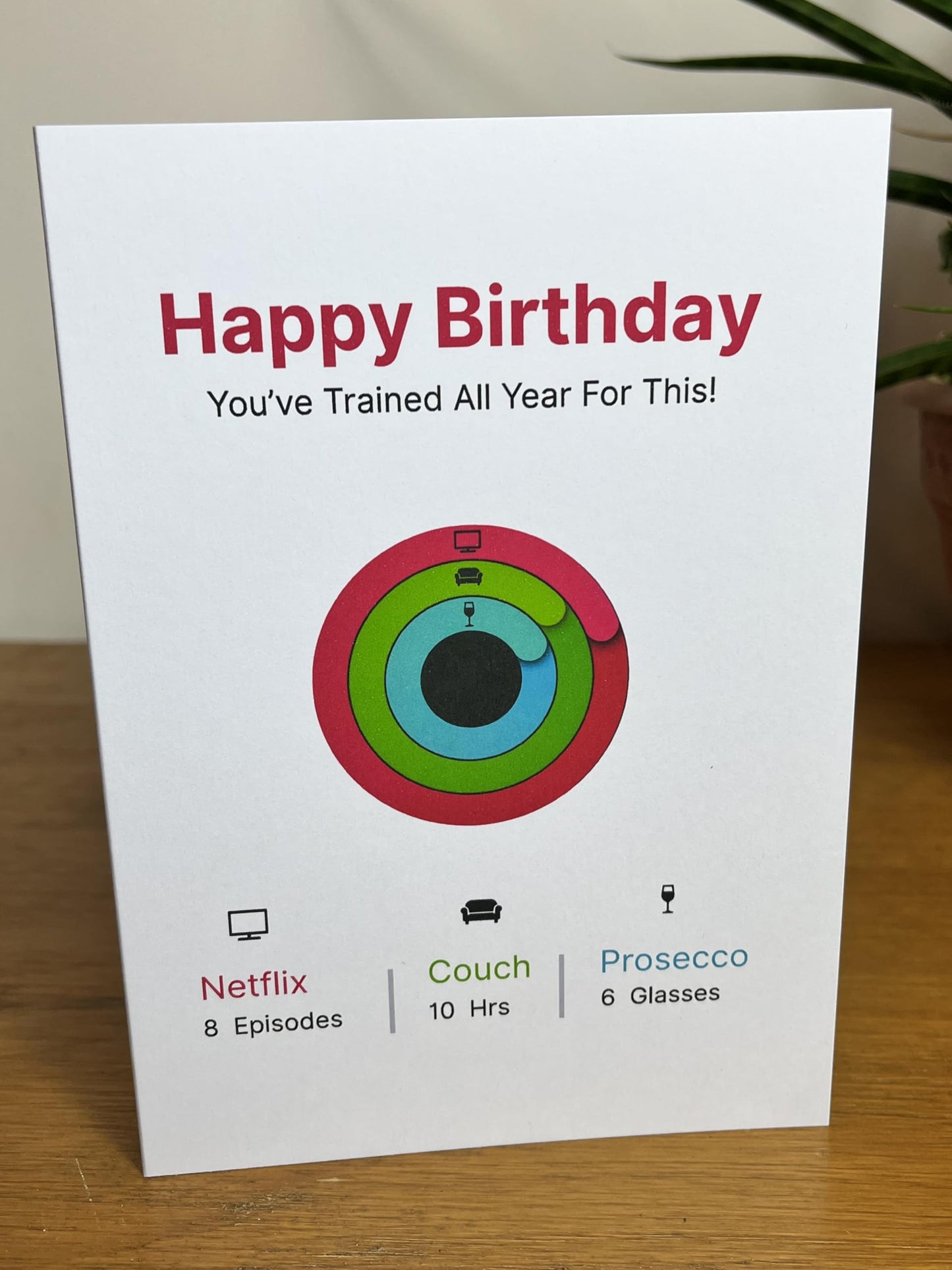 Funny Activity Ring (Prosecco, TV & Couch) Fitness Tracker Birthday Card. You've trained all year for this!
